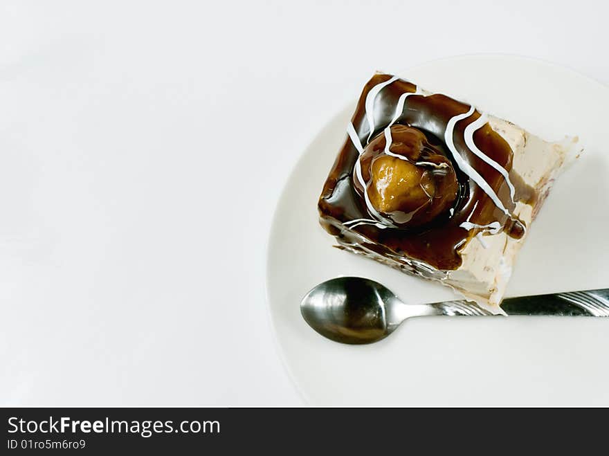 Profiterole covered with chocolate syrup on white plate. Profiterole covered with chocolate syrup on white plate