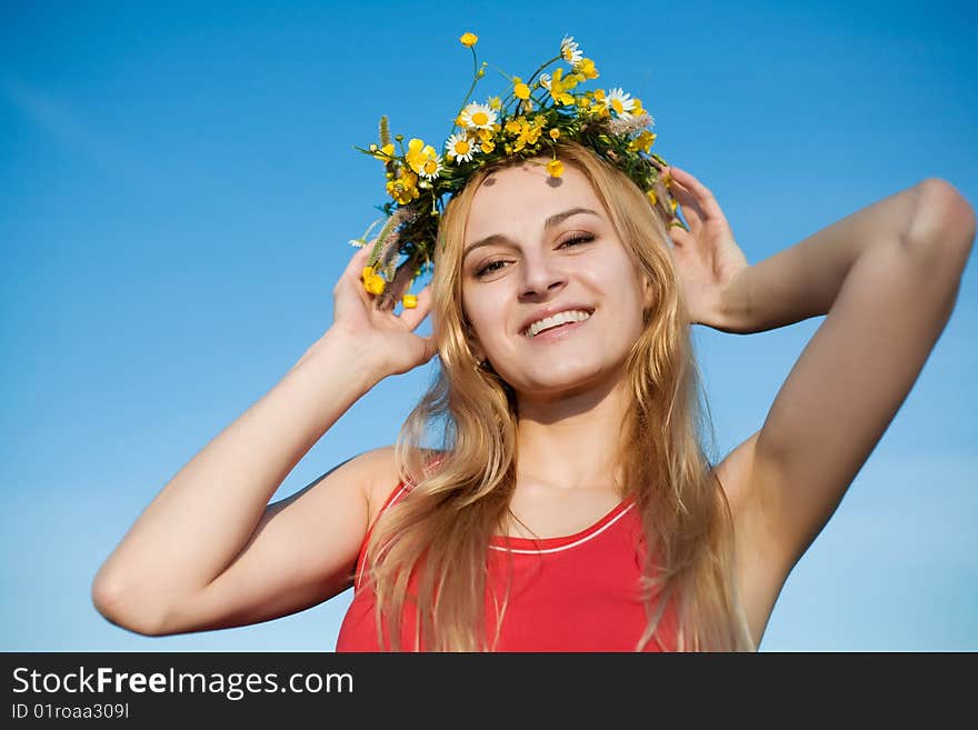 A portrait of pretty girl in a chaplet of summer flowers. A portrait of pretty girl in a chaplet of summer flowers