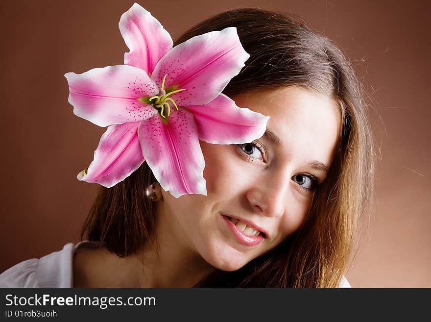 Young Woman Posing With A Pink Lily