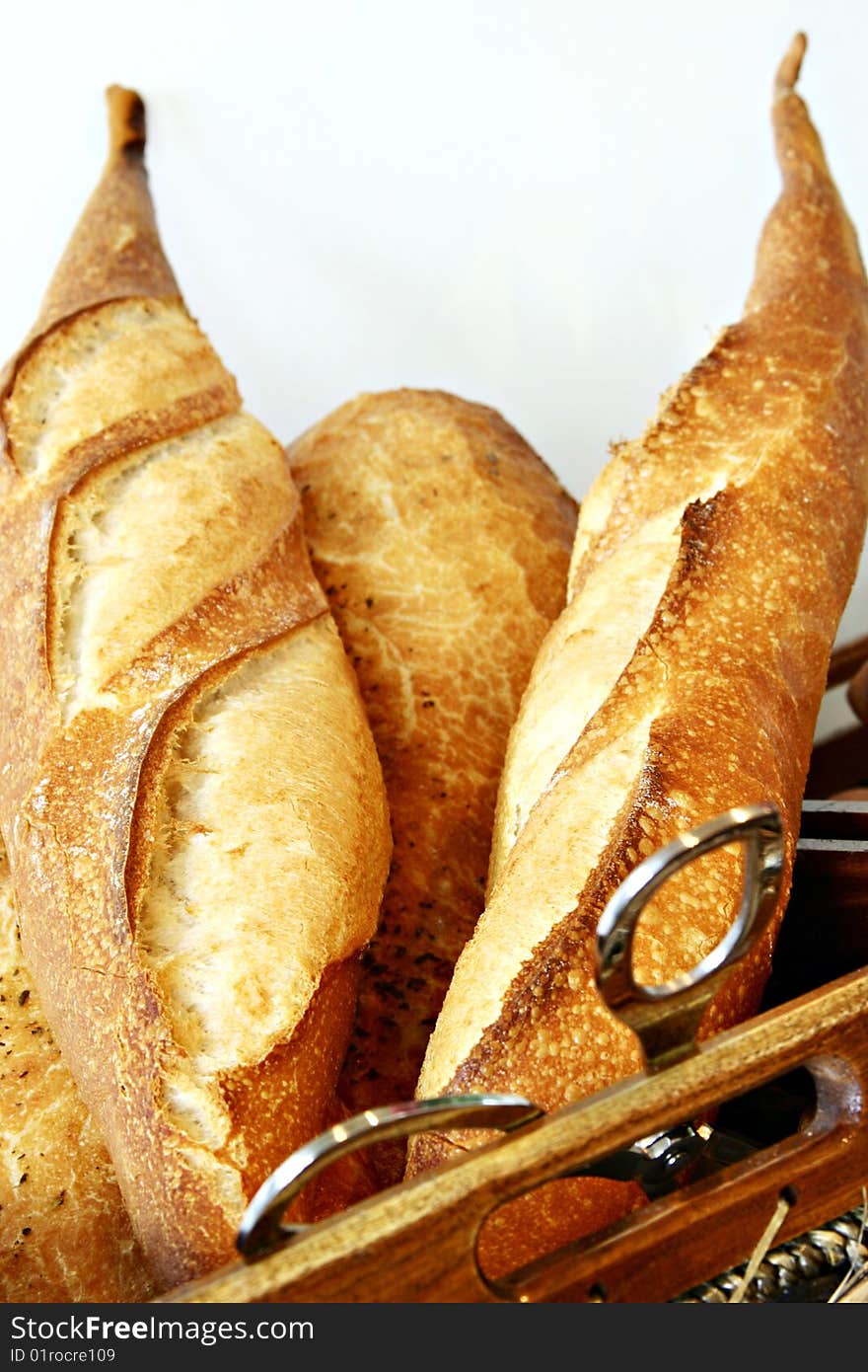 Bread in basket on wooden plate