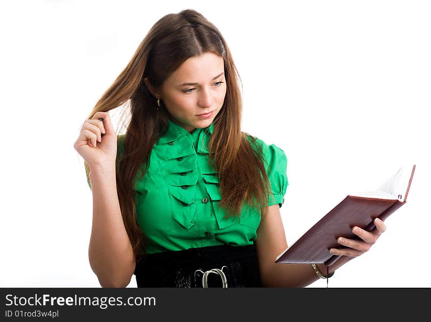 A graceful female student with a pen and a copybook in her hands