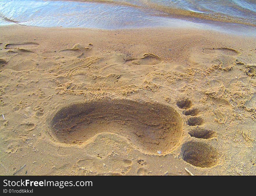 Trace of very big foot on the sand. Trace of very big foot on the sand