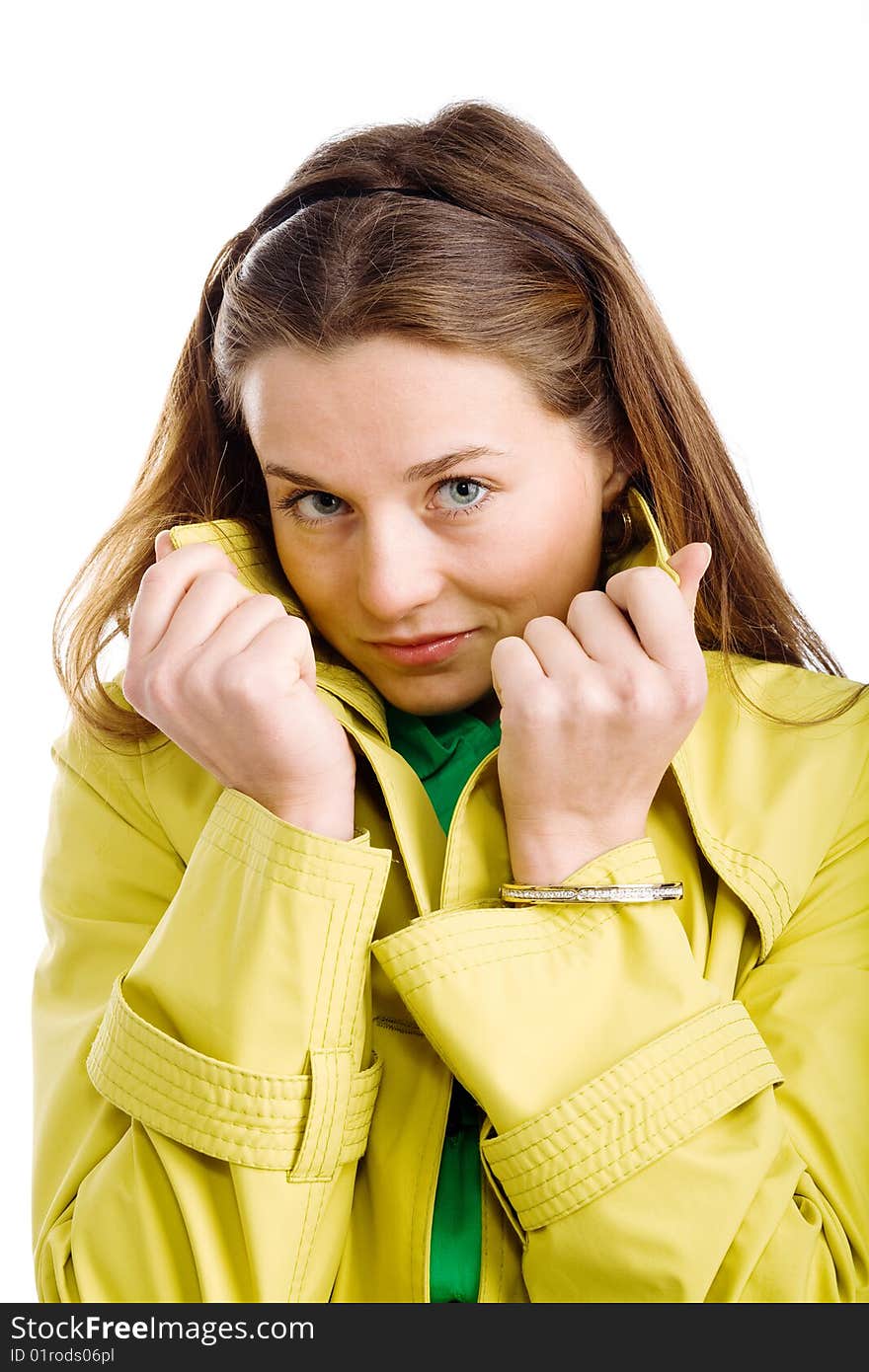 A pretty young woman in a yellow raincoat, isolated on white. A pretty young woman in a yellow raincoat, isolated on white