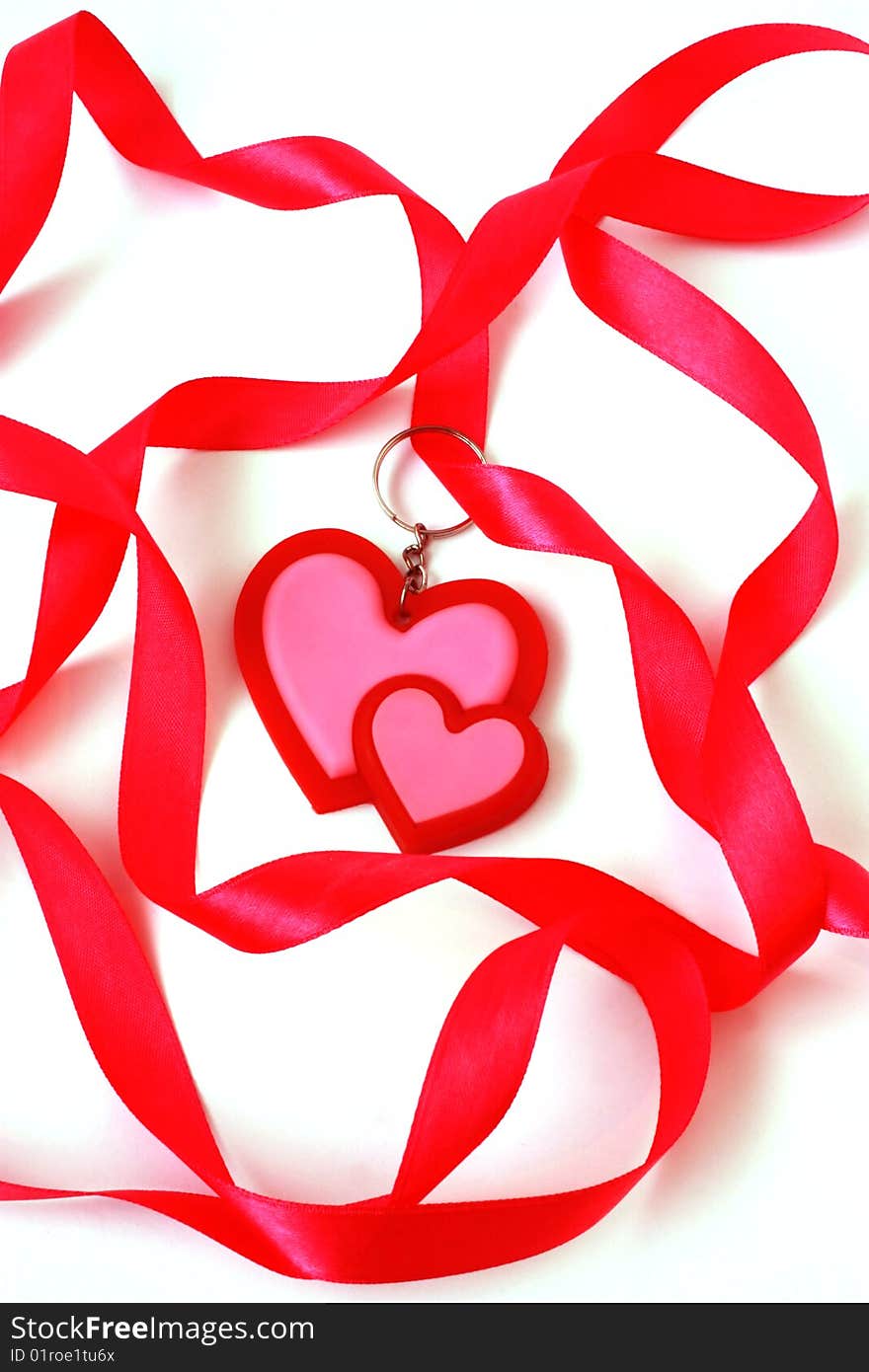 A red heart is in a ribbon