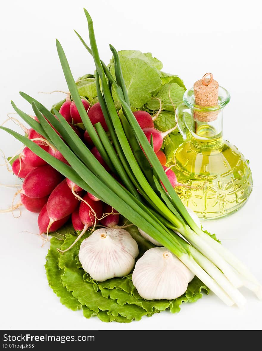 Green vegetables and  bottle of oil