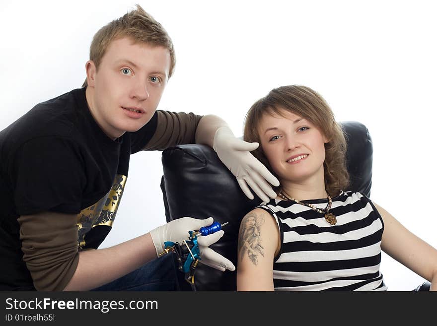 A man drew tattoo pictures on woman arm. A man drew tattoo pictures on woman arm