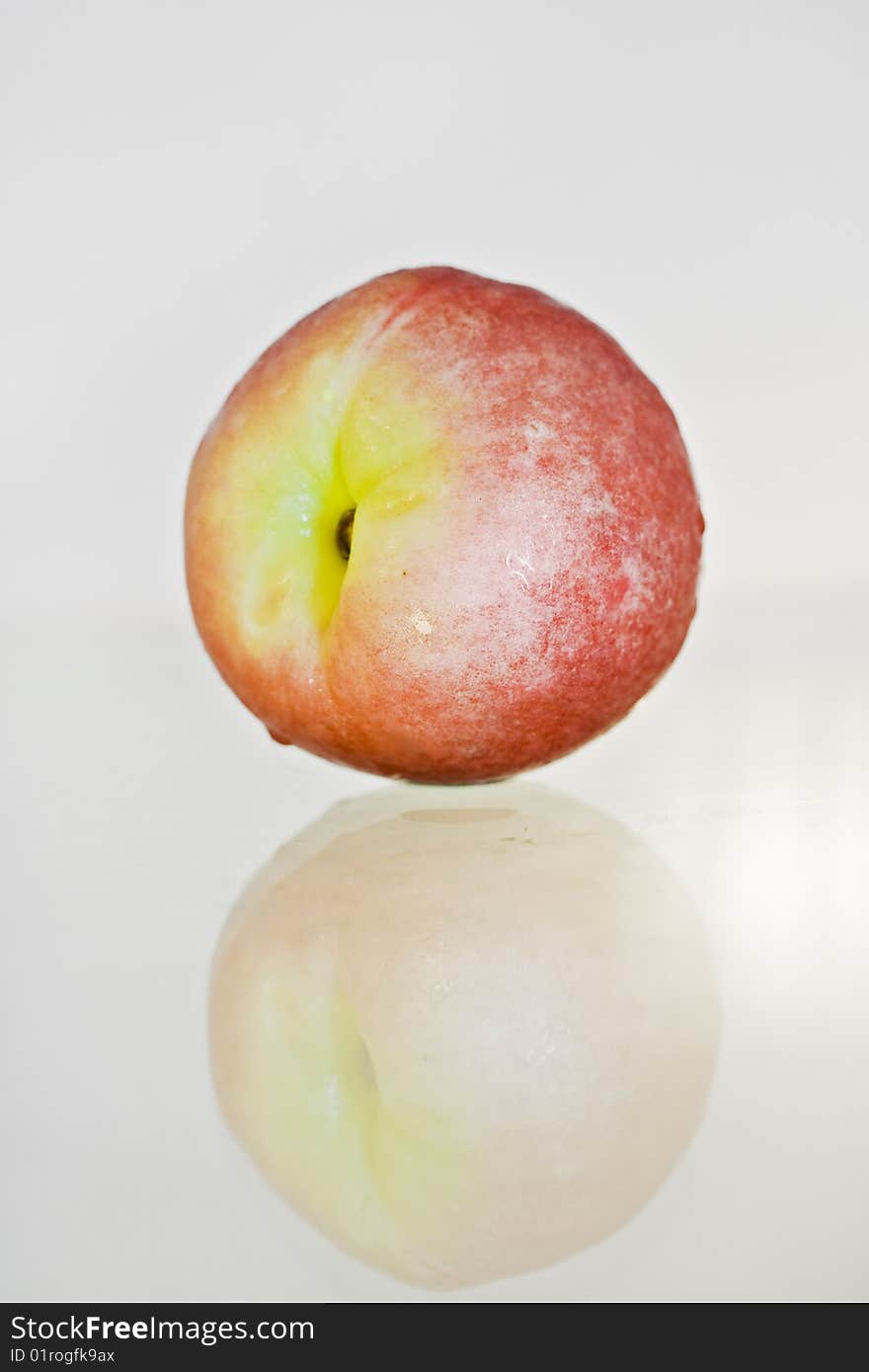 Delicious fresh peach closeup isolated and reflected. Delicious fresh peach closeup isolated and reflected