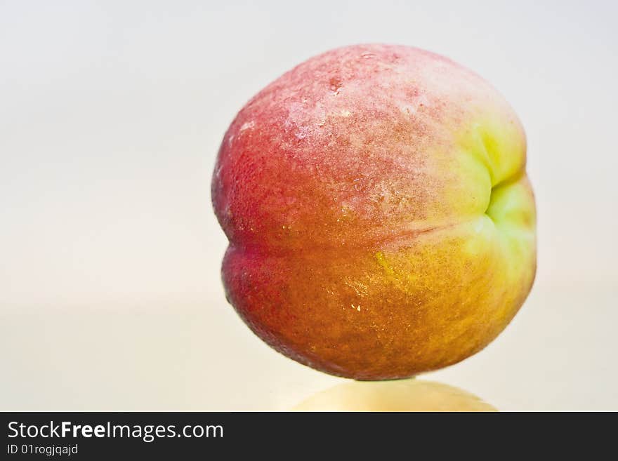 Delicious fresh peach closeup isolated and reflected. Delicious fresh peach closeup isolated and reflected