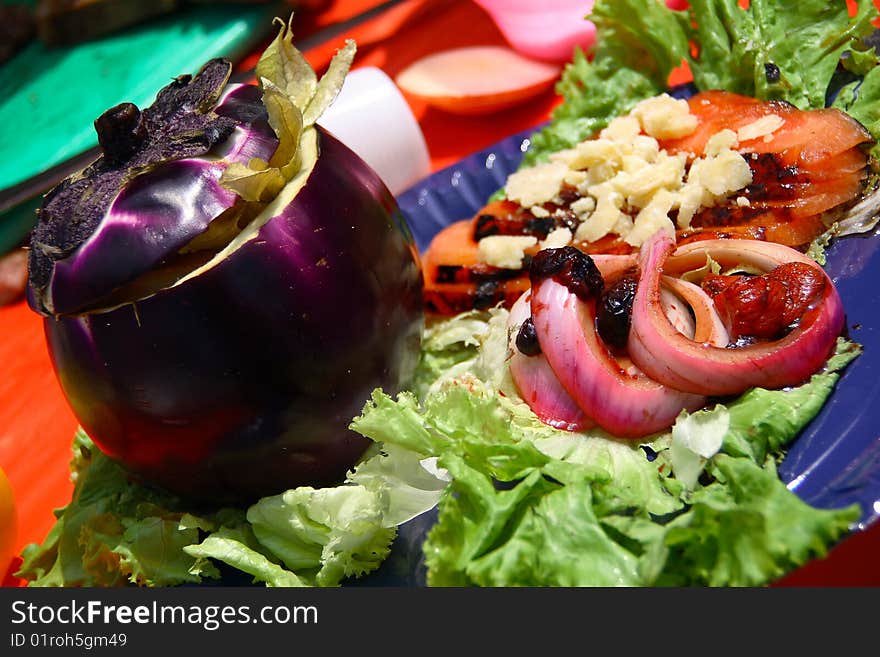 Summer dish consisting of eggplant stuffed with grilled vegetables and crumbs of cheese grana. Summer dish consisting of eggplant stuffed with grilled vegetables and crumbs of cheese grana