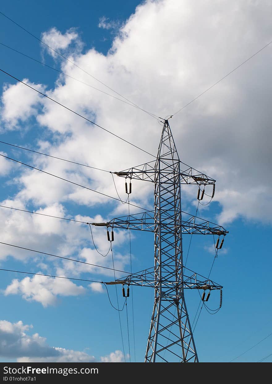 High-voltage line on the cloudy sky background. High-voltage line on the cloudy sky background