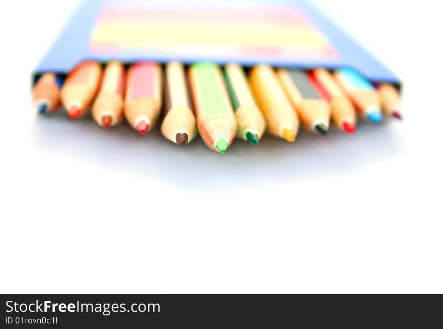 Colorful pencils in pencil-box on white background.