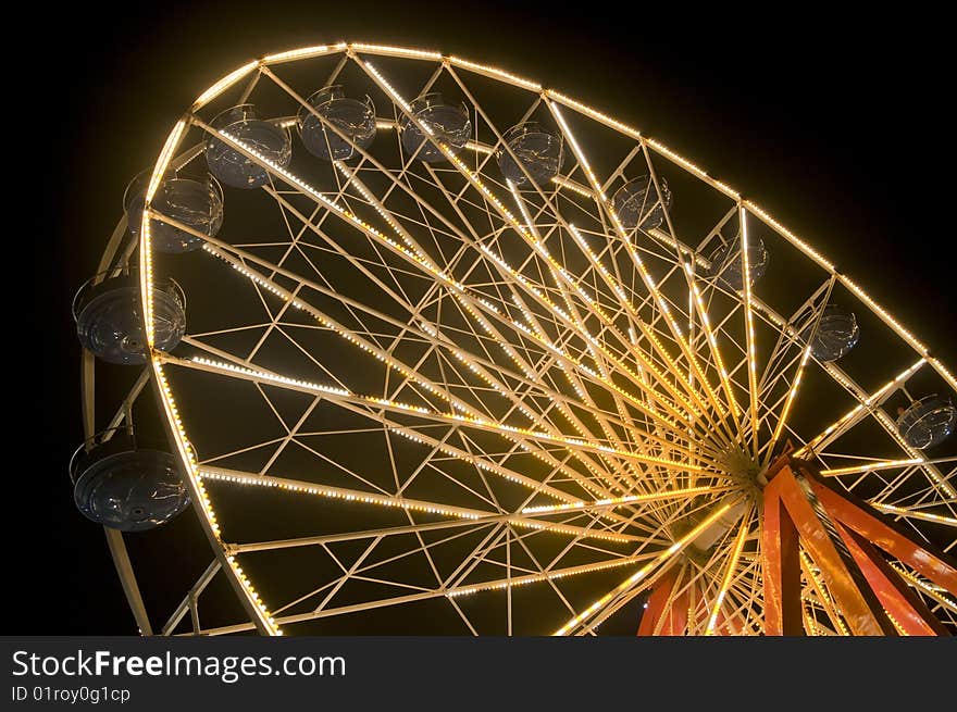 Side view of ferris wheel at night