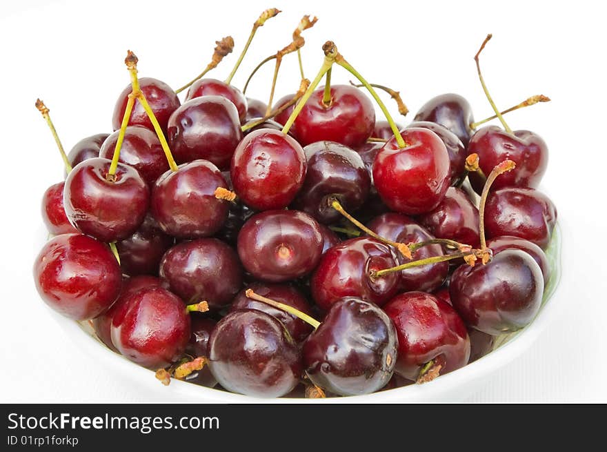 Large red juicy sweet cherry with shanks on a white background