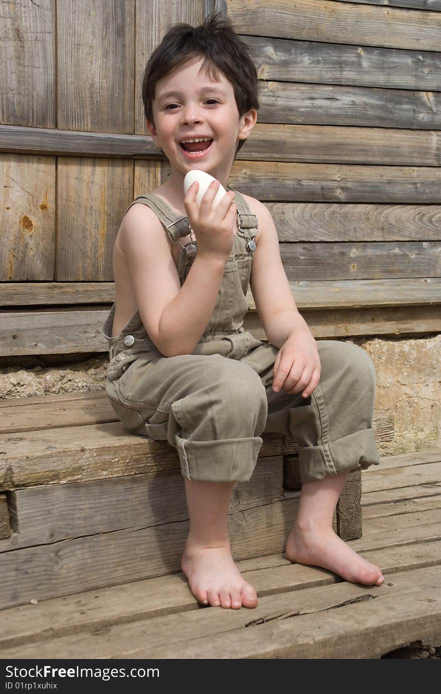 The boy with big goose egg on porch of house. The boy with big goose egg on porch of house