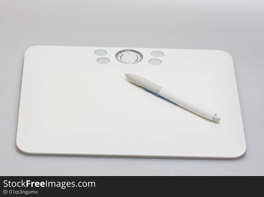 Tablet with pen on gray