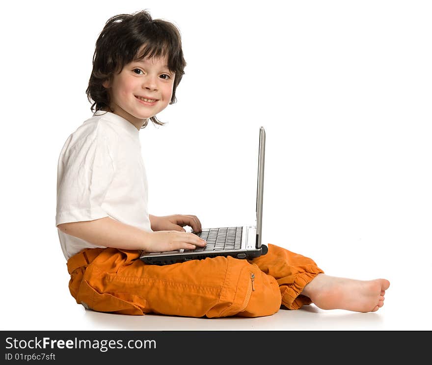 The merry  boy with laptop on white background. The merry  boy with laptop on white background