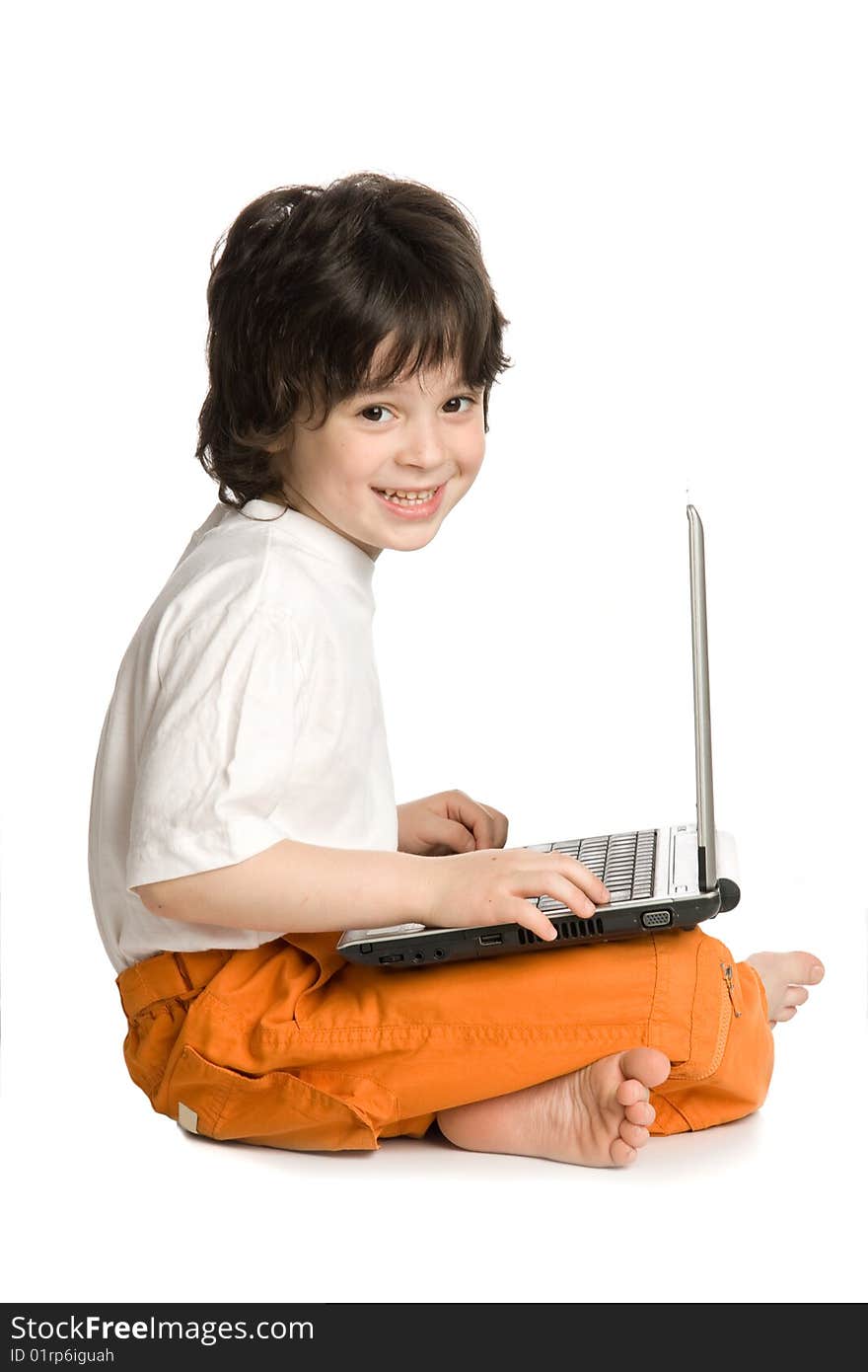 The merry boy with laptop on white background