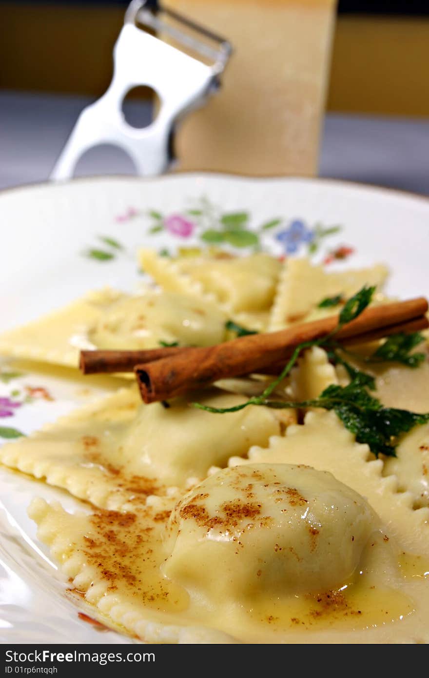 Ravioli and cinamon on white plate