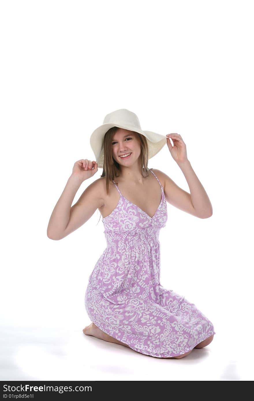 Pretty teen in purple dress and floppy hat