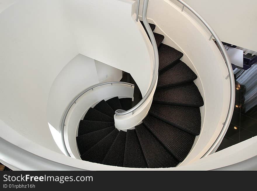 Spiral staircase with white walls in luxury home