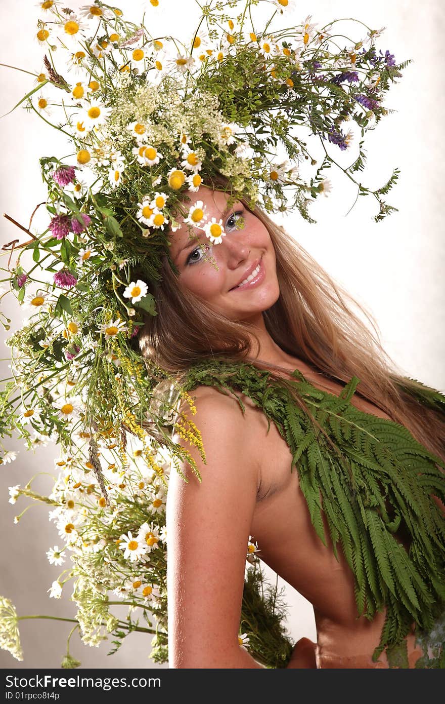 Girl in flowers on a bright background. Girl in flowers on a bright background