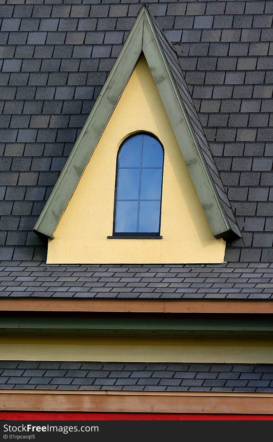 Small window on a roof of cape cord style home. Small window on a roof of cape cord style home