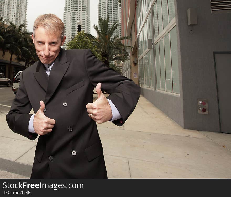 Mature businessman with thumbs up