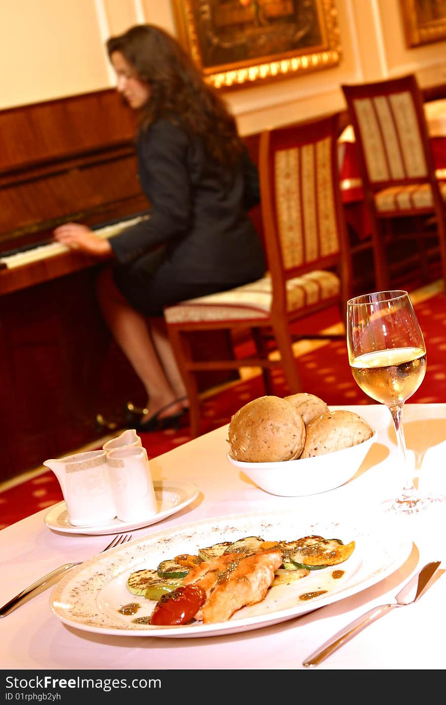 Woman in restorant playing piano. Woman in restorant playing piano