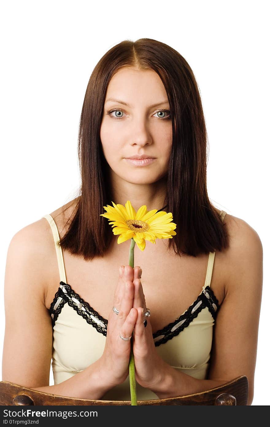 A beautiful girl with a yellow flower in her hands