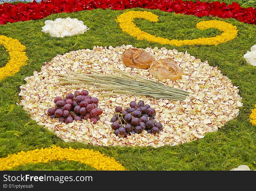 Grapes, bread, corn on a bed of petals. Grapes, bread, corn on a bed of petals