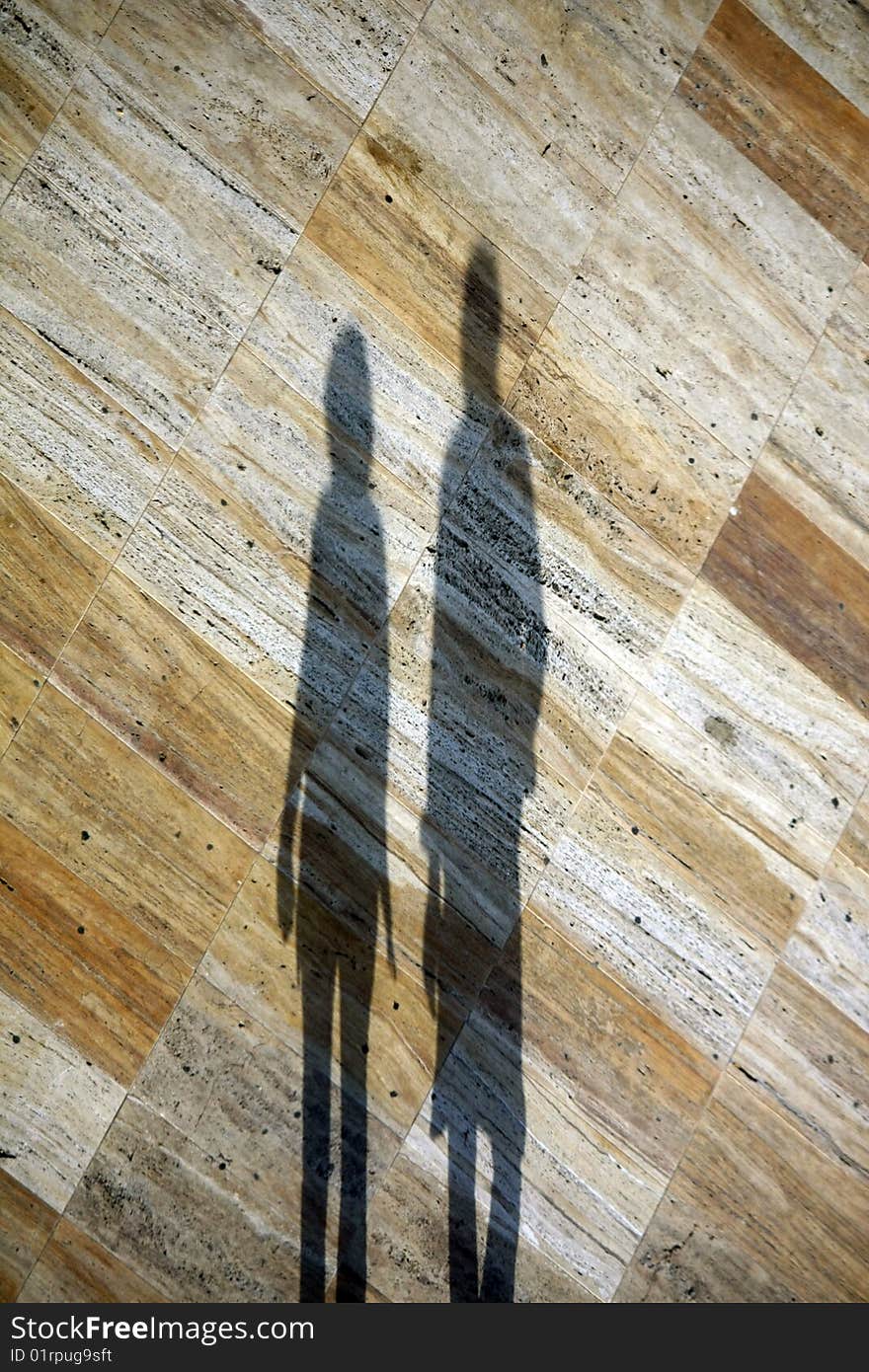 Two shadows on marble floor