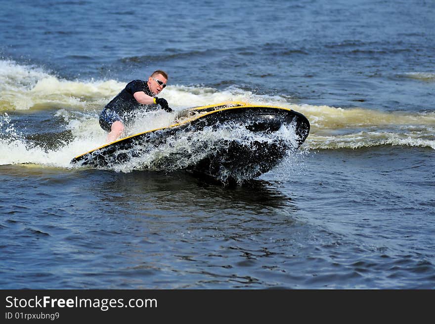 Young man riding jet ski