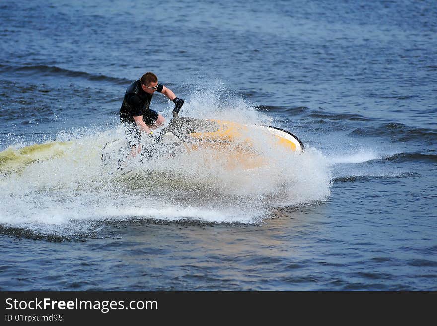 Young man riding jet ski