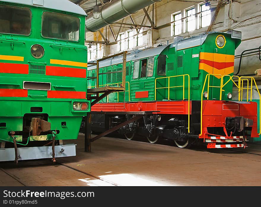 Two old locomotives in repair hangar are ready to use