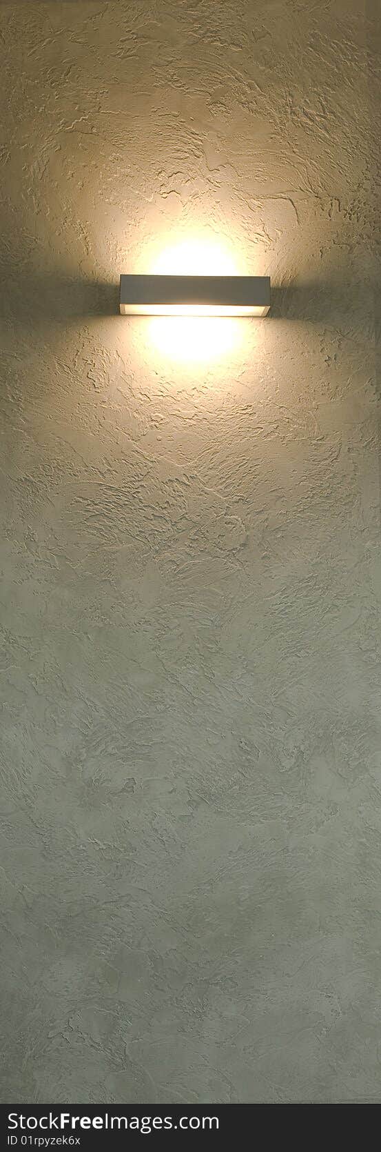 Lamp on wall with decorative plaster