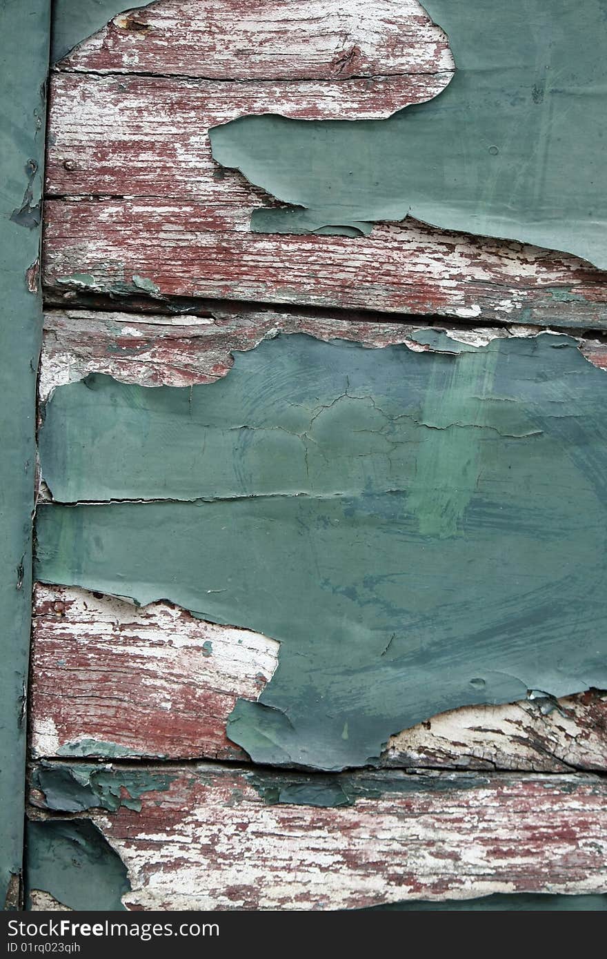 View of a texture old wooden door with paint peeling. View of a texture old wooden door with paint peeling.