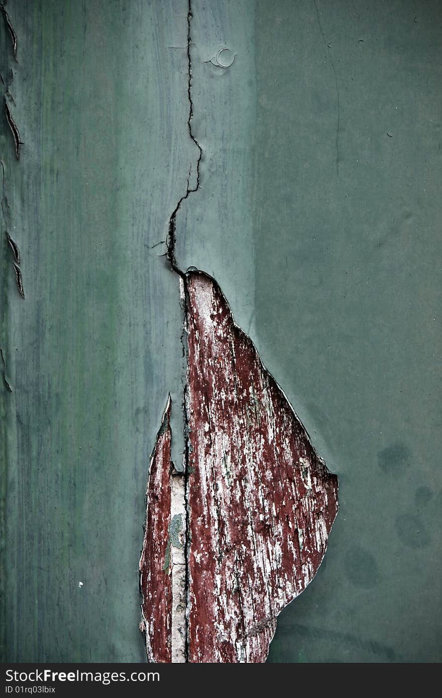 View of a texture old wooden door with paint peeling. View of a texture old wooden door with paint peeling.