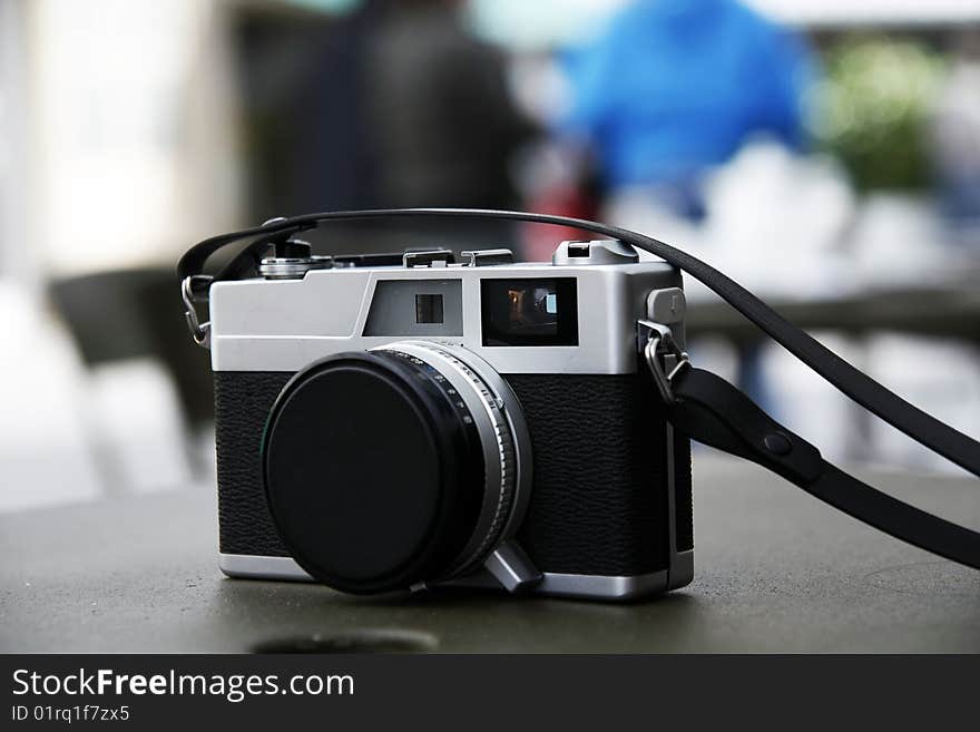 Close view of a digital camera on top of a table. Close view of a digital camera on top of a table.