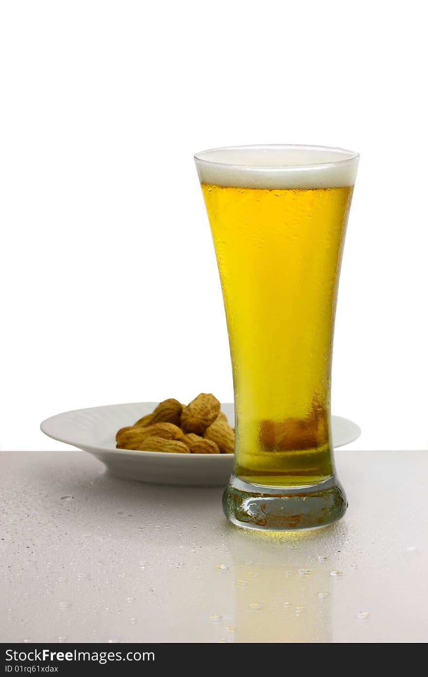 Glass of beer and bowl of peanuts isolated on white