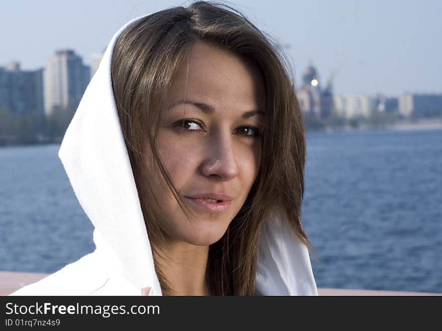 A young attractive girl goes for a walk near the river. A young attractive girl goes for a walk near the river