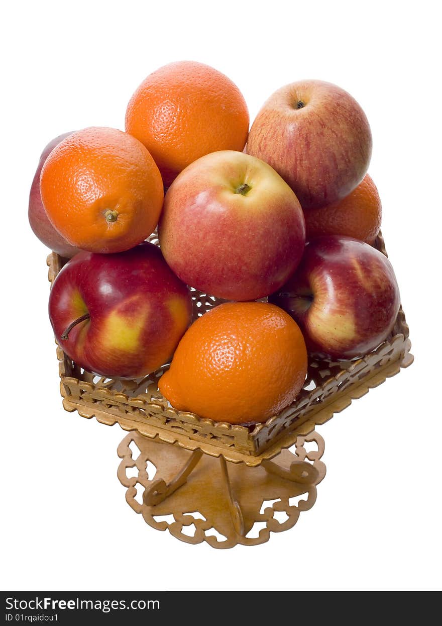 Apples and mandarins in the wood carved bowl on white background