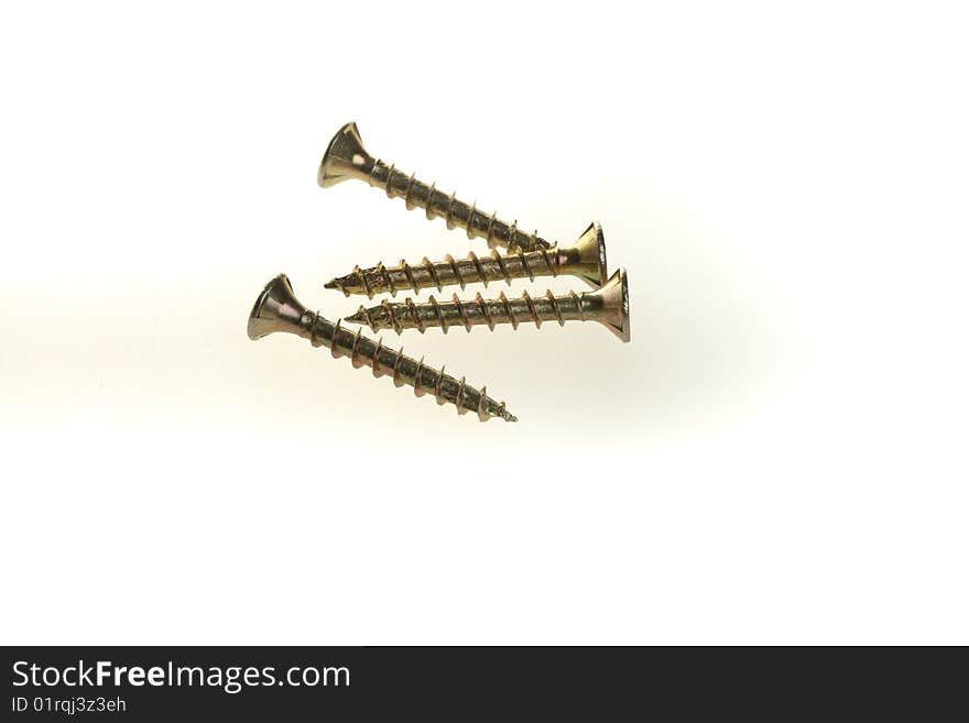 Some screws arranged on a white background, isolated.