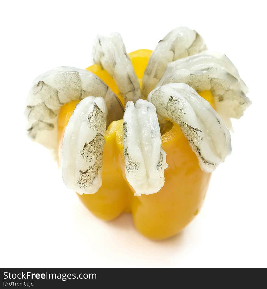 Shell off vannamei prawns in emptied yellow pepper isolated on white background taken from side