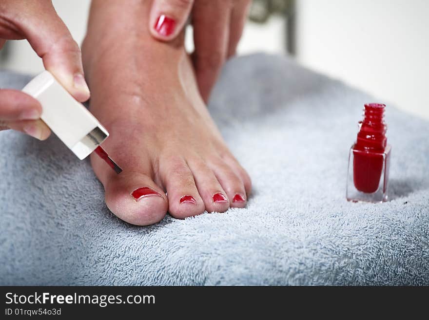 Toes with red nail polish. In beauty salon. Toes with red nail polish. In beauty salon