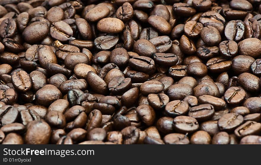 Background from the spilled grains of Brazilian coffee