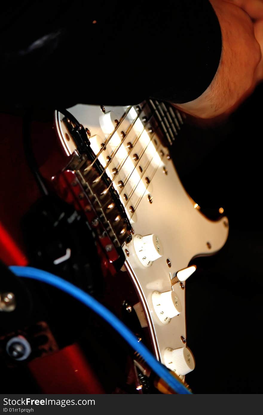 Musician on stage playing the electric guitar. Musician on stage playing the electric guitar.