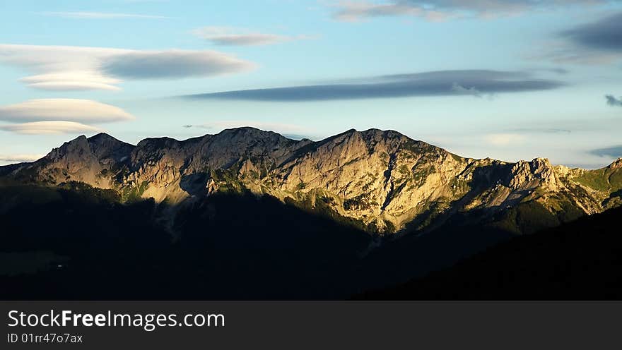 Nice clouds and mountains in evening sun. Nice clouds and mountains in evening sun.