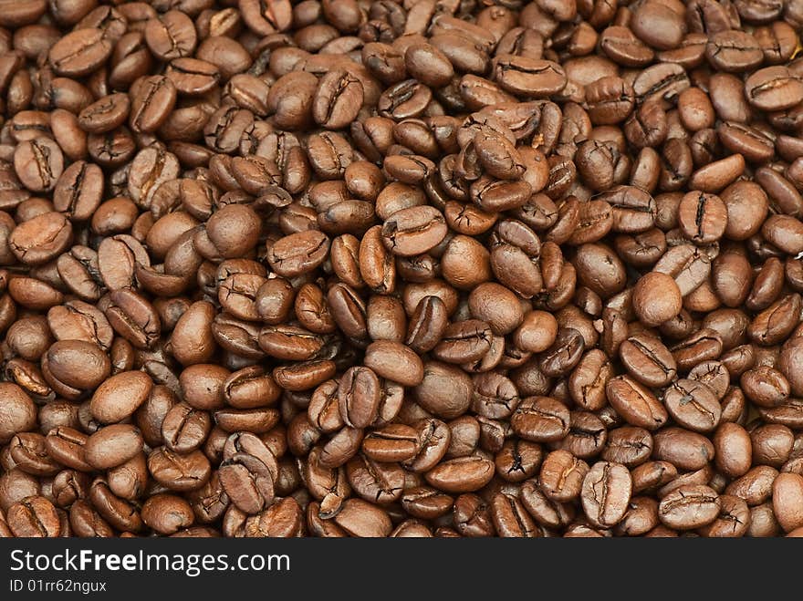 Background from the spilled grains of Brazilian coffee