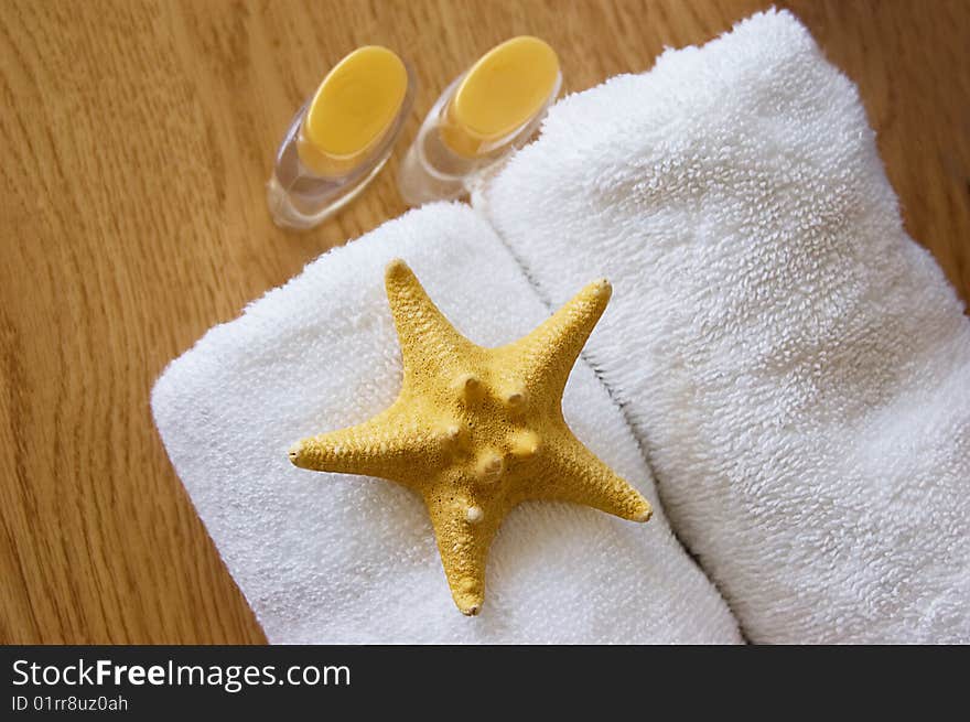 Body care and spa background with towels and shell