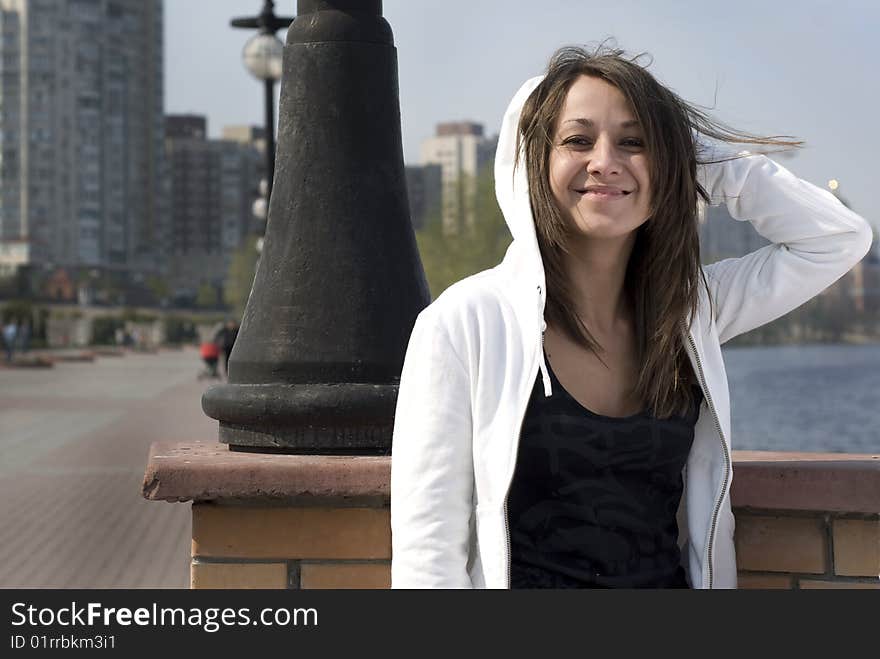 A girl laughing in a park, on a walk near the river. A girl laughing in a park, on a walk near the river